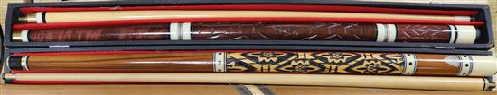 Two snooker cues, cased